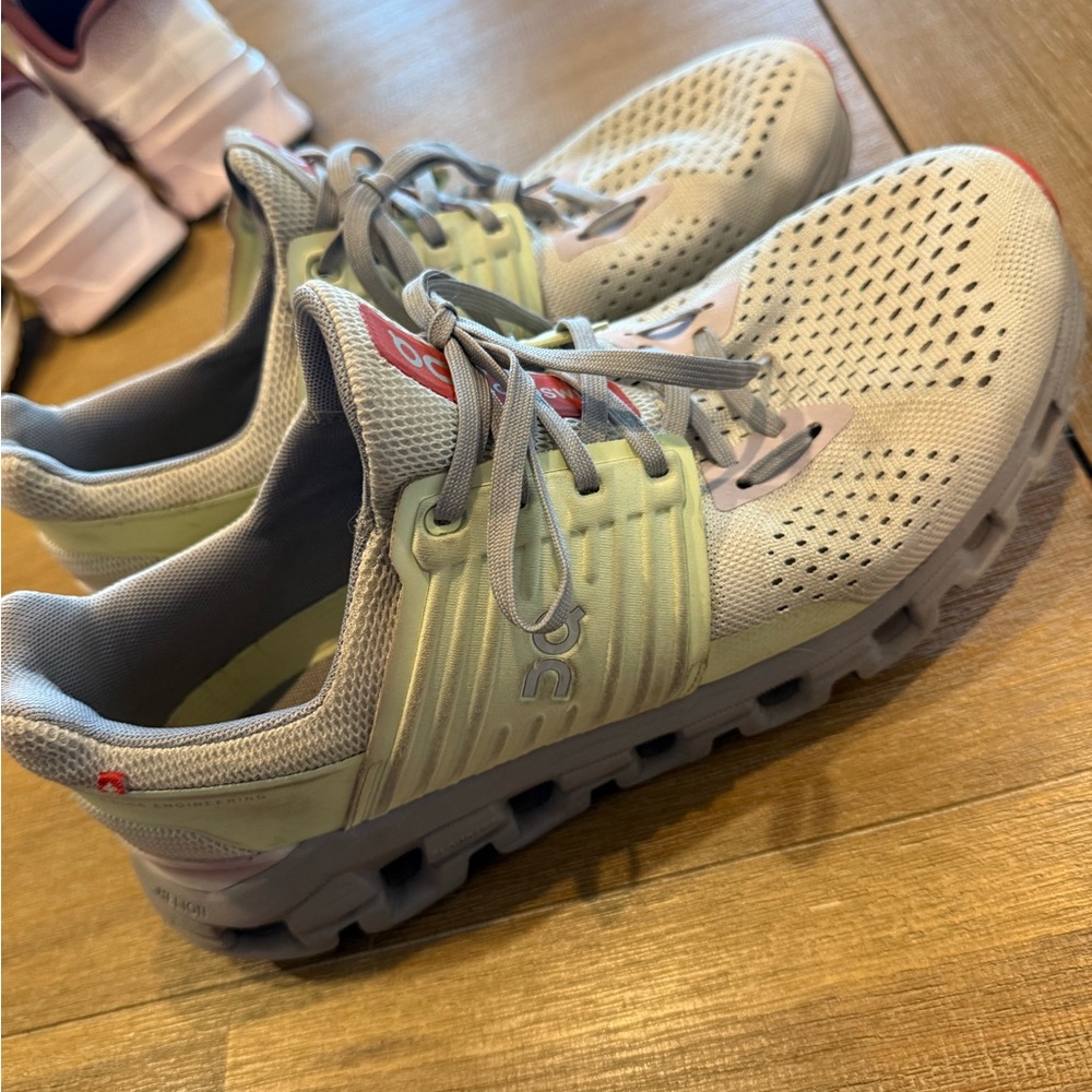 On Running Gray and Red Athletic Shoes